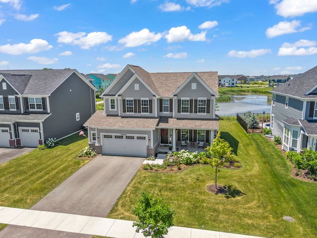 view of front of property featuring a water view, a front lawn, and a garage