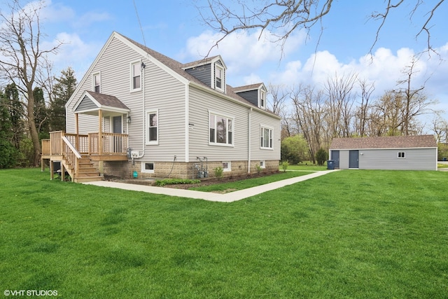 back of property with a wooden deck and a lawn