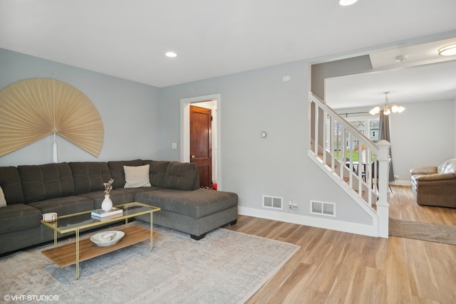 living room featuring hardwood / wood-style flooring and a notable chandelier