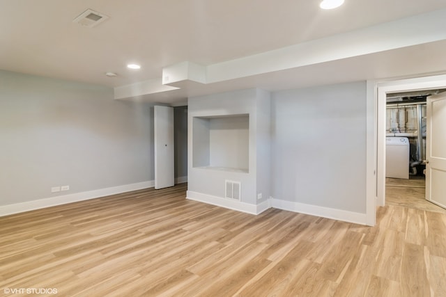 empty room with light wood-type flooring and washer / dryer