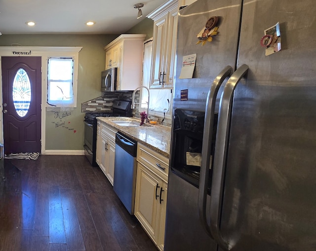 kitchen featuring stainless steel appliances, dark hardwood / wood-style floors, sink, and stone countertops