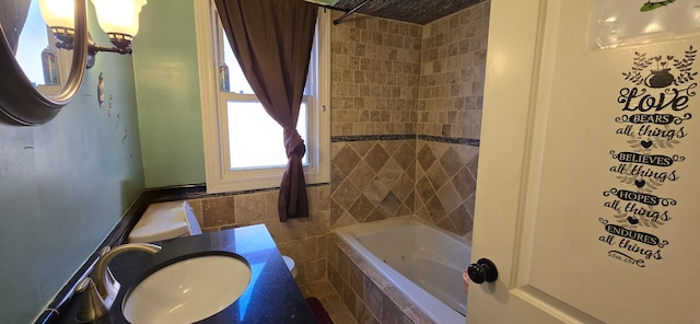 bathroom with vanity and tiled shower / bath combo