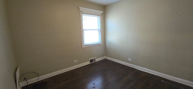 unfurnished room with dark hardwood / wood-style floors