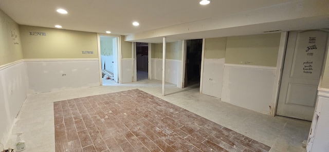 basement with light hardwood / wood-style flooring