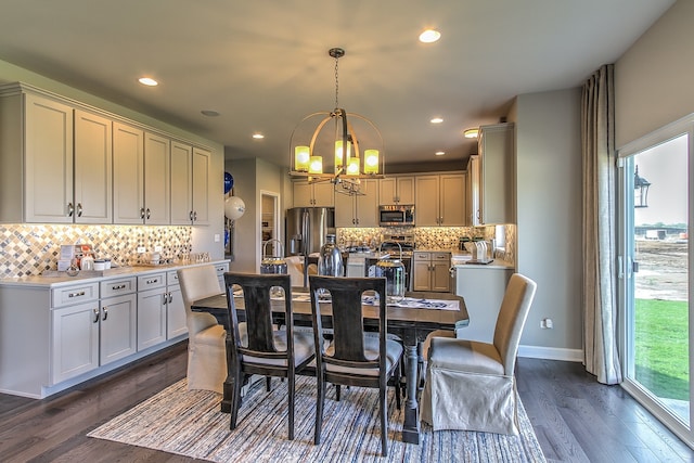 dining space featuring dark hardwood / wood-style floors and a chandelier