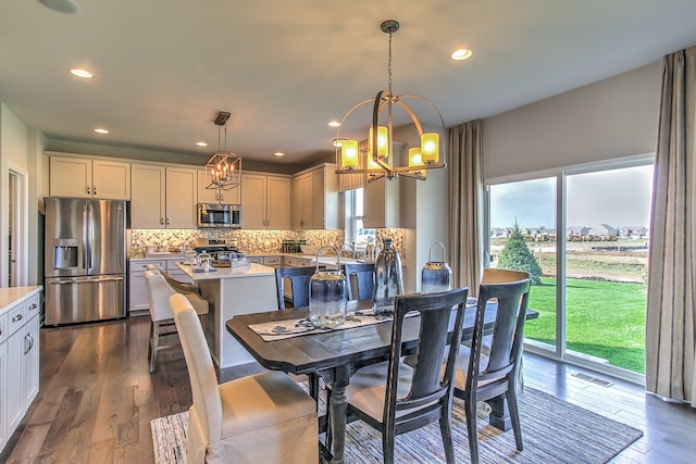 dining space with a notable chandelier and dark wood-type flooring