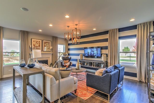 living room with a notable chandelier and dark hardwood / wood-style flooring