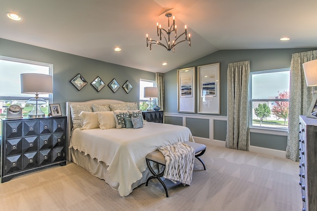 carpeted bedroom featuring an inviting chandelier and vaulted ceiling