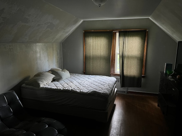 bedroom with dark hardwood / wood-style floors and vaulted ceiling