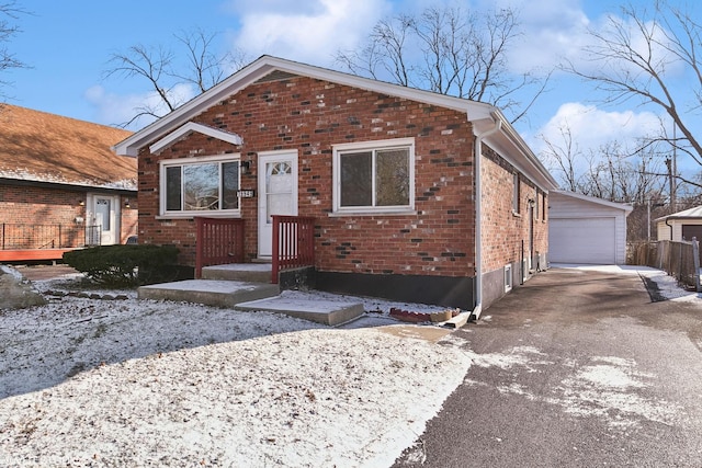 view of front of property with a garage and an outdoor structure