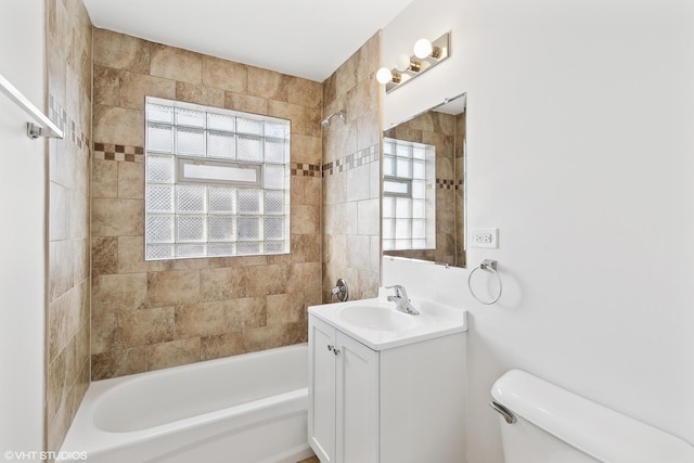 full bathroom with vanity, toilet, and tiled shower / bath combo