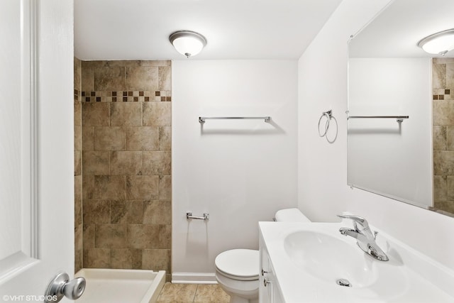 bathroom with a shower, tile patterned floors, vanity, and toilet