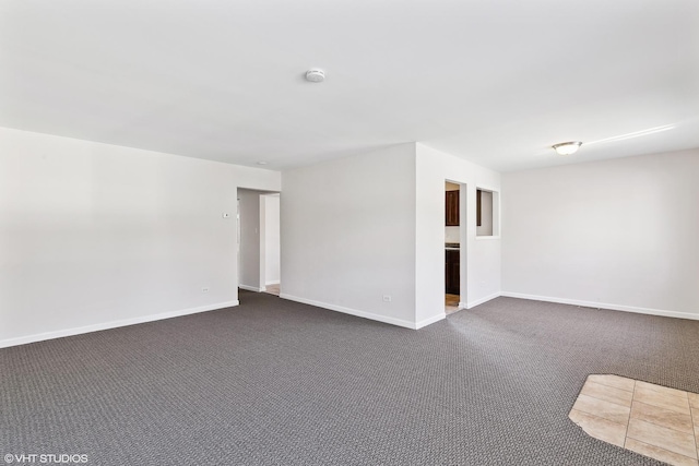 empty room with dark colored carpet