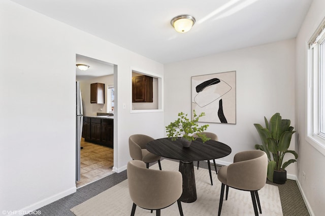 carpeted dining area featuring plenty of natural light