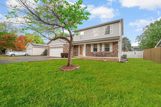 view of property featuring covered porch, a front yard, central AC, and a garage