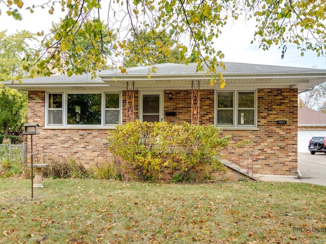 view of front of house with a front yard and a garage