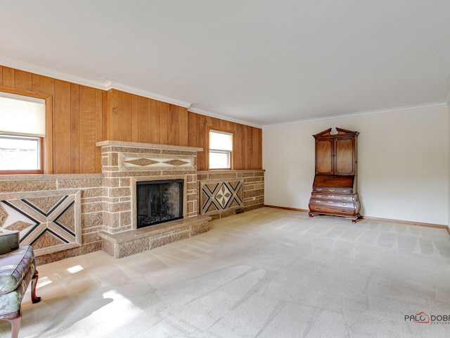 unfurnished living room with a fireplace, light colored carpet, a healthy amount of sunlight, and ornamental molding