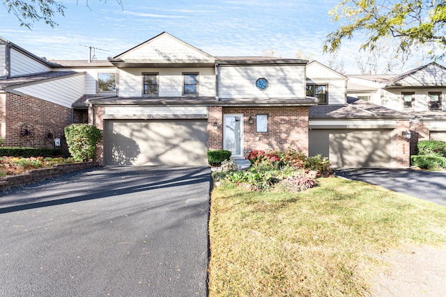 view of front of house featuring a front yard and a garage