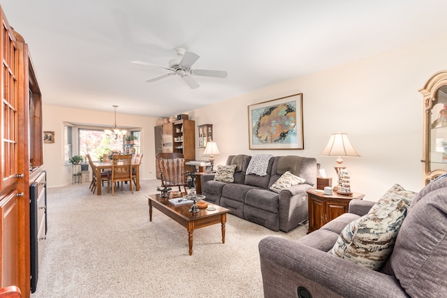 living room with light colored carpet and ceiling fan with notable chandelier