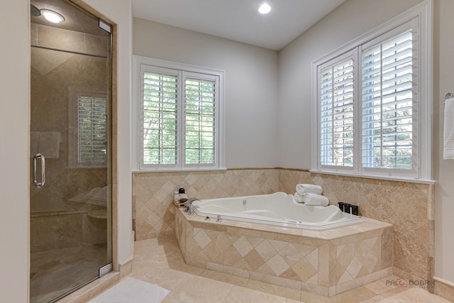 bathroom featuring tile patterned floors and shower with separate bathtub