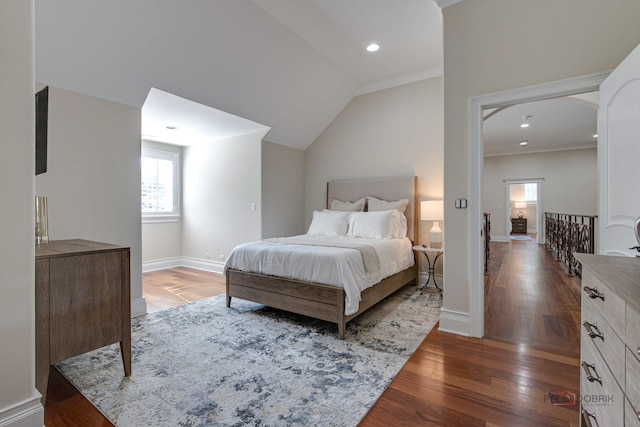 bedroom featuring dark wood-type flooring, crown molding, and lofted ceiling