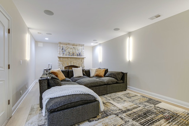 living room with a fireplace and light hardwood / wood-style floors