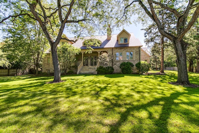 cape cod home with a front lawn