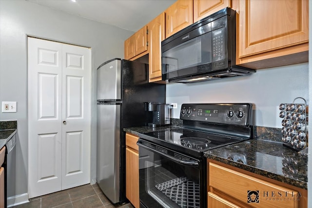 kitchen with black appliances, dark stone countertops, and dark tile patterned flooring