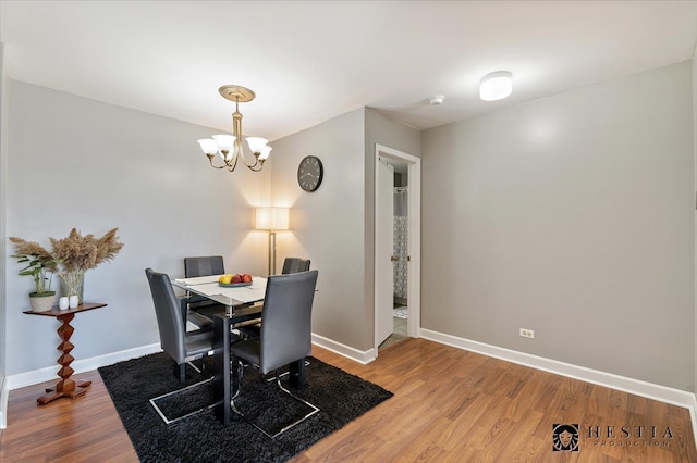 dining room featuring an inviting chandelier and wood-type flooring