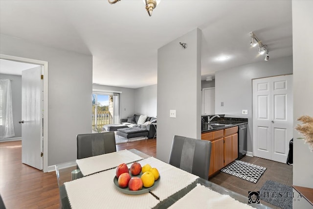 dining area with dark hardwood / wood-style floors and sink