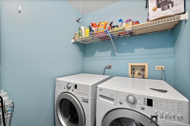 clothes washing area with washing machine and dryer