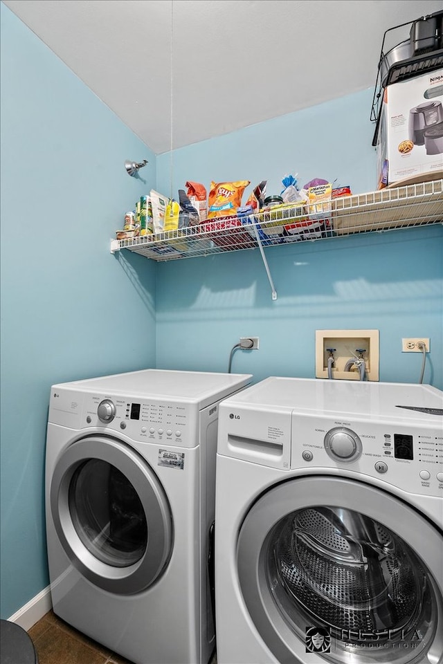 clothes washing area featuring independent washer and dryer and dark tile patterned floors