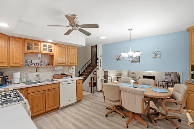 kitchen with ceiling fan with notable chandelier, pendant lighting, light hardwood / wood-style floors, sink, and white appliances