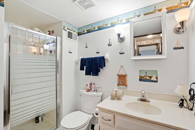 bathroom featuring a shower with door, vanity, and toilet