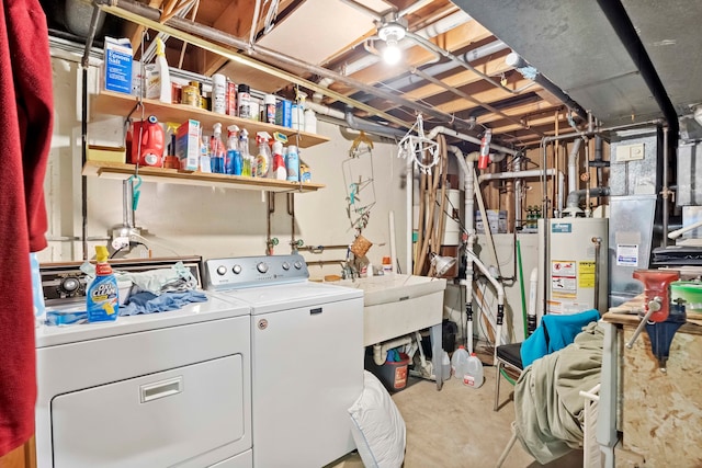 washroom with sink, washing machine and clothes dryer, and gas water heater