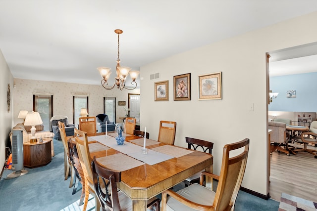 dining room with a notable chandelier and hardwood / wood-style floors