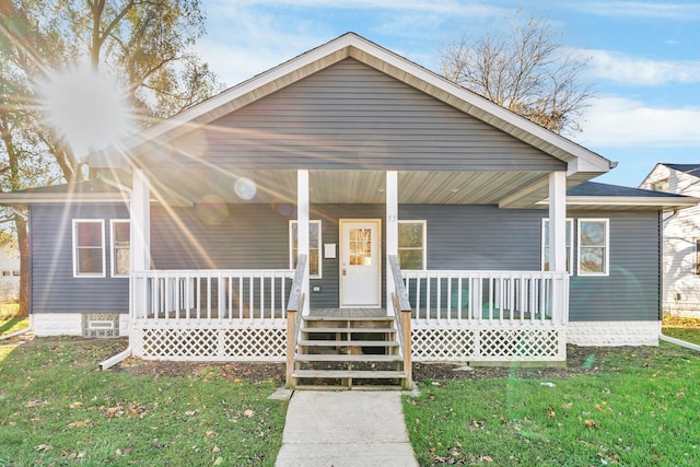 bungalow-style house with a porch and a front lawn