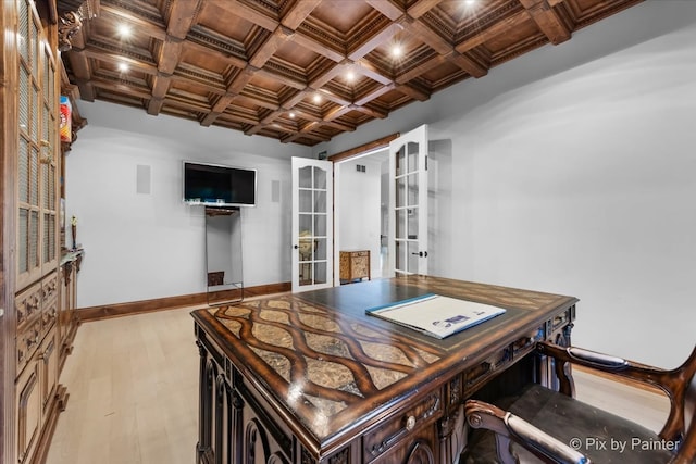 office space with beamed ceiling, coffered ceiling, french doors, and light hardwood / wood-style flooring