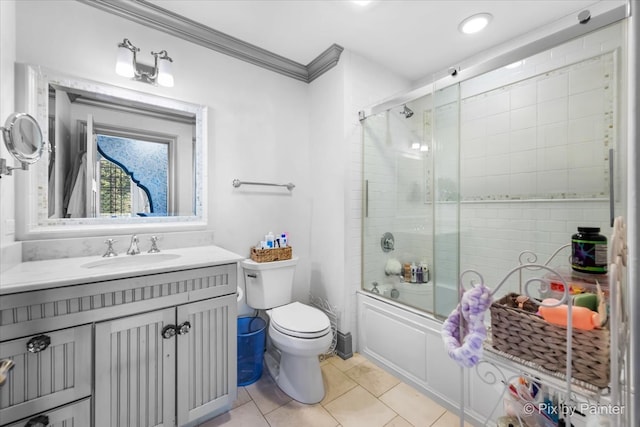 full bathroom featuring vanity, toilet, ornamental molding, bath / shower combo with glass door, and tile patterned flooring