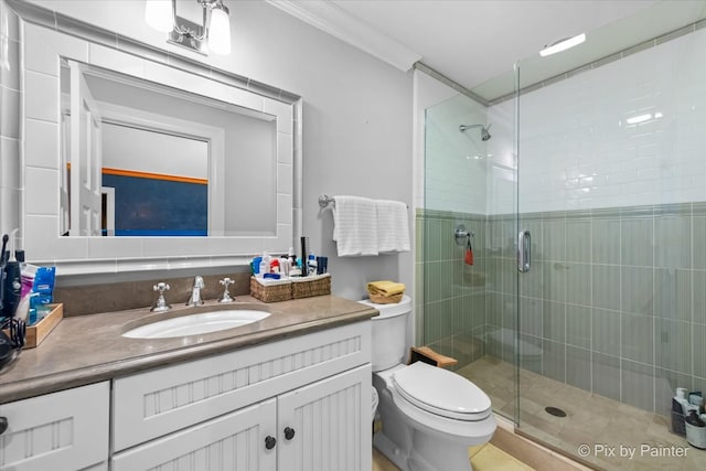 bathroom with ornamental molding, vanity, walk in shower, and toilet