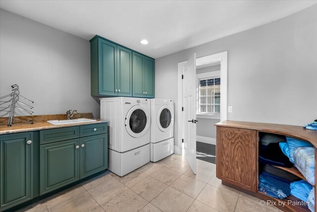 washroom featuring light tile patterned floors, cabinets, sink, and independent washer and dryer