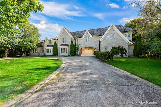 view of front of property with a garage and a front yard