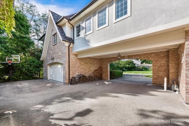 view of side of home featuring a garage