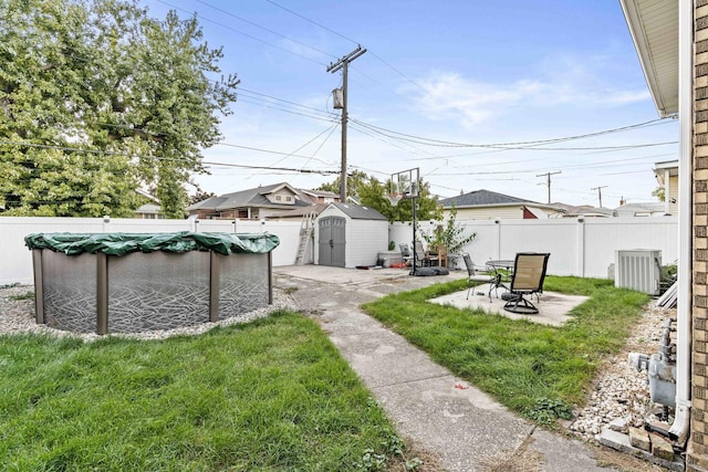 1632 Stanton Ave, Whiting, IN 46394 - view of yard with a storage shed, a fenced in pool, a fenced backyard, and a patio area