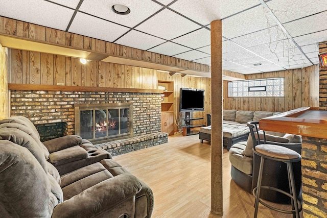 1632 Stanton Ave, Whiting, IN 46394 - living area featuring wood finished floors, wooden walls, a fireplace, and a paneled ceiling