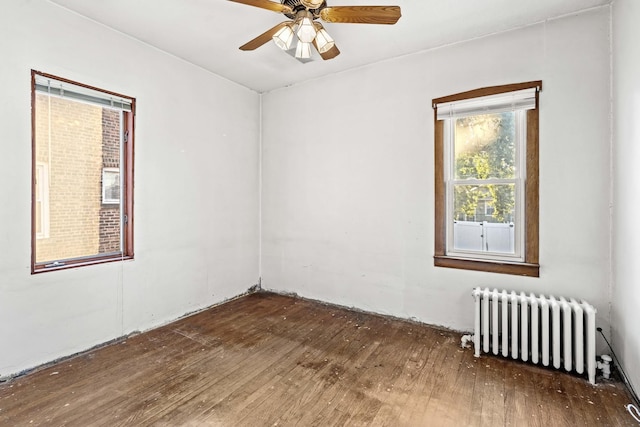 1632 Stanton Ave, Whiting, IN 46394 - empty room featuring wood-type flooring, a ceiling fan, and radiator heating unit