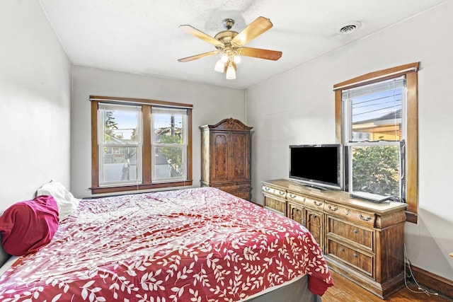 1632 Stanton Ave, Whiting, IN 46394 - bedroom with wood finished floors, visible vents, and a ceiling fan