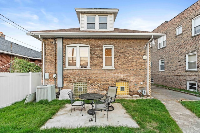 rear view of house featuring central AC unit and a patio