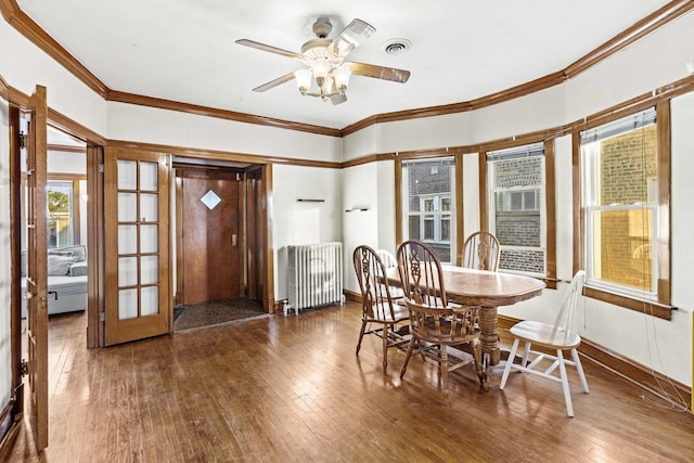 1632 Stanton Ave, Whiting, IN 46394 - dining area featuring radiator, ceiling fan, wood-type flooring, visible vents, and crown molding