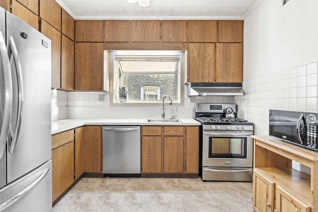 1632 Stanton Ave, Whiting, IN 46394 - kitchen featuring a sink, under cabinet range hood, tasteful backsplash, light countertops, and appliances with stainless steel finishes
